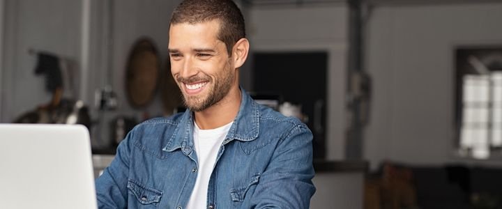 Happy Guy Using Laptop